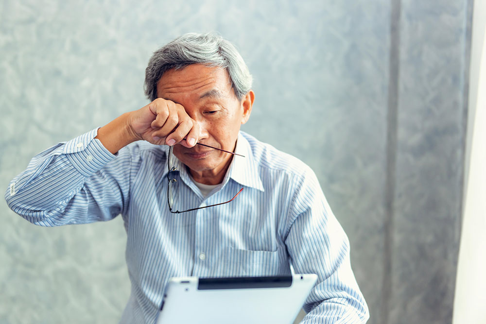 man rubbing his eyes, macular degeneration awareness month at new jersey eye center bergenfield